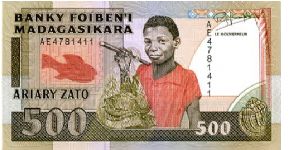 500 Francs
Brown/Red/Green
Fish, Boy with fish in net & sea shell
Aerial view of port   
Security thread
Wtmrk Zebu's head Banknote