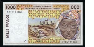 1000 Francs.

Workmen hauling peanuts to storage and woman's head on face; twin statues and mask on left, two women with baskets, elevated riverside storage bins in background on back.

Pick #311C-h Banknote
