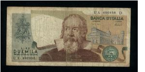 2,000 Lire.

Galileo at center, ornate arms at left, buildings and leaning tower of Pisa at right; signs of the Zodiac on back.

Pick #103a Banknote