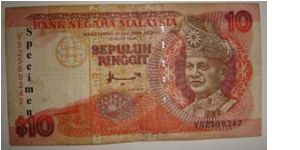 Malaysia 10 Ringgit Front Design: DYMM the First Yang Di Pertuan Agong's portrait on front was surrounded by a design pattern from a typical Dayak shield (Sarawak), stylised design of the kingfisher bird bottom. Banknote