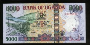 5,000 Shillings.

Lake Bunyonyi, terraces at left on face; Railroad cars being loaded onto Kaawa Ferry at center, plant at lower right on back.

Pick #NEW Banknote