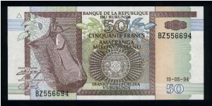50 Francs.

Man in dugoout canoe at left, arms at lower center on face; four men with canoe at center, hippopotamus at lower right on back.

Pick #36 Banknote
