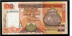 100 Rupees.

Decorative urn at right on face; tea leaf pickers, two parrots at bottom on back.

Pick #111 Banknote