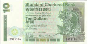 Standard Charted Bank $10 note from 1993

Design changes on this version include the shrinkage of the stip on the left handed side, change of building on the back and the lotus flower replacing the Royal seal Banknote