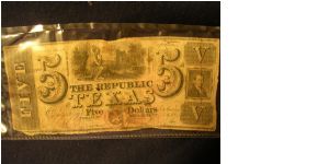 The Republic of Texas; Five dollar note.  Mirabou B. Lamar signature.  Cancelled at bottom with an X cut through the paper.

This note was found in an old agricultural book, stuck away in a chest. Banknote