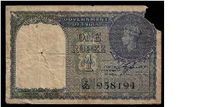 Britsh 'Government of India' 1 rupee dated 1940, # Z/93 958194. P-25a. Poor condition with the top right corner missing and a small hole in the left half. Banknote