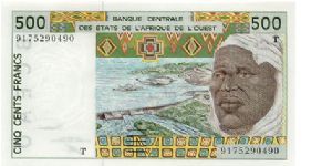 Dam on front, farm machine on back.   
The T marks this note as being from Togo. Banknote