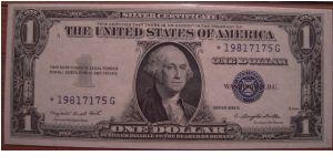 1935 G $1 silver certificate (good for one dollar of silver when redeemed) - STAR note (replacement for error notes) - signatures of Smith and Dillon - with motto variety (has In God We Trust on reverse) - Friedberg # 1617*, 1,080,000 star notes printed. Certified Choice Uncirculated 64 with Exceptional Paper Quality by Paper Money Guarantee. Banknote