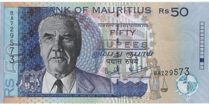 50 Rupees  
1999; 2001; 2003. Black, purple and deep blue on multicolor underprint. J. M. Paturau at left, arms at lower left, building facades at center, standing Justice with scales at lower right in underprint. Ascending size serial number. Signature 7. Back: Building complex at center right. Watermark: Dodo bird's head
 Banknote