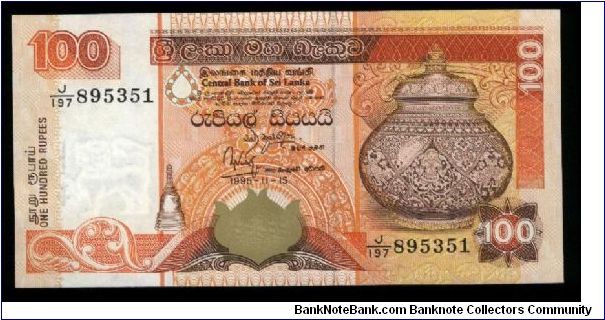 100 Rupees.

Decorative urn at right on face; tea leaf pickers, two parrots at bottom on back.

Pick #111 Banknote