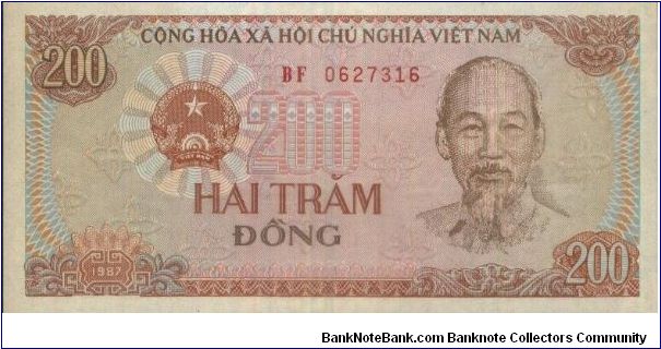 200 Dong Dated 1987.(O)Ho Chi Minh(R)Field workers & Tractor. Banknote