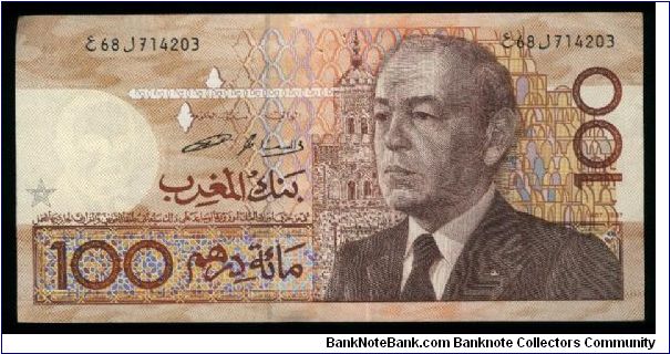 100 Dirhams.

Older bust of King Hassan II at right on face; demonstration at center on back.

Pick #65c Banknote