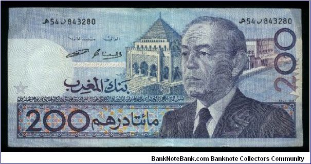 200 Dirhams.

Older bust of King Hassan II at right, mausoleum of King Muhammad V at center on face; sailboat, shell and coral on back. Banknote