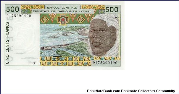 Dam on front, farm machine on back.   
The T marks this note as being from Togo. Banknote