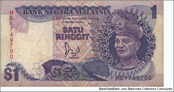  1 Ringgit  
ND (1986; 1989). Dark blue and purple on multicolor underprint. T. A. Rahman at right. Signature Datuk Jaafar Hussein. Vertical serial number. Back: National Monument Kuala Lumpurate at center. Watermark: T. A. Rahman. Printer: TDLR.
 Banknote