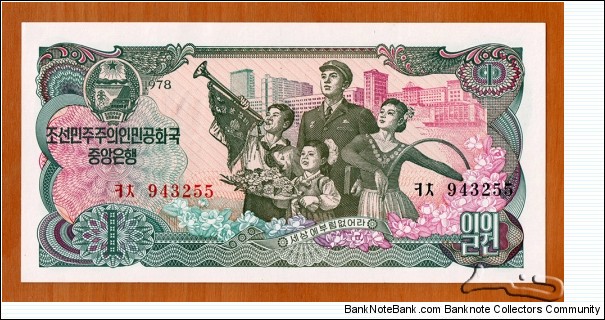 North Korea | 
1 Wŏn, 1978 – For general circulation | 

Obverse: People and Modern buildings in North Korea symbolizing 